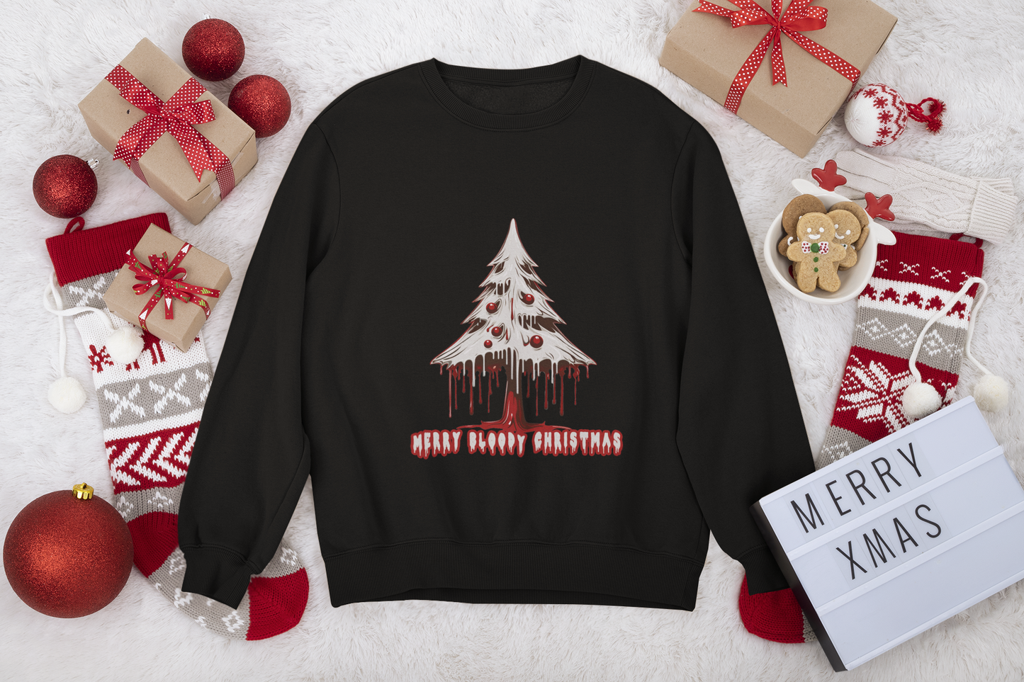 Black sweatshirt with "Merry Bloody Christmas" tree graphic, set among festive holiday decor and gifts.