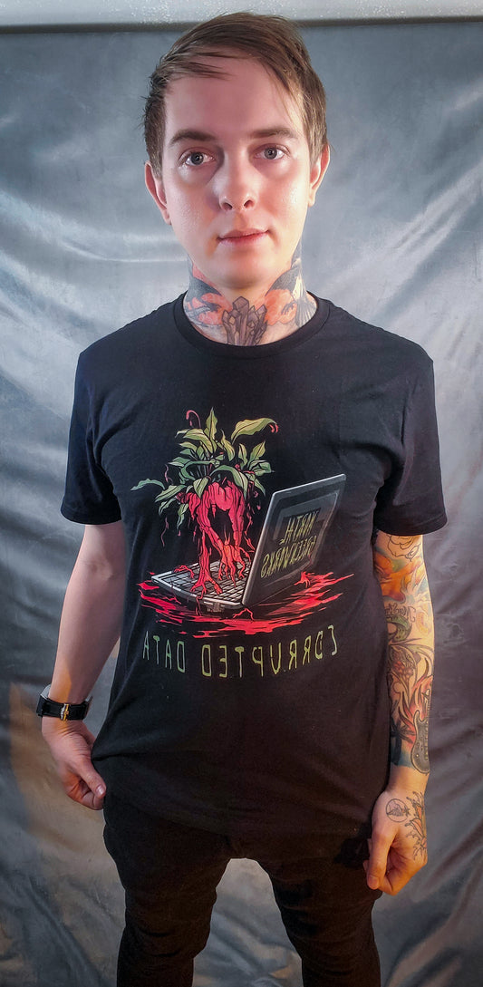 Person wearing a black t-shirt with a graphic of an infected radish emerging from a laptop, with 'Corrupted Data' text