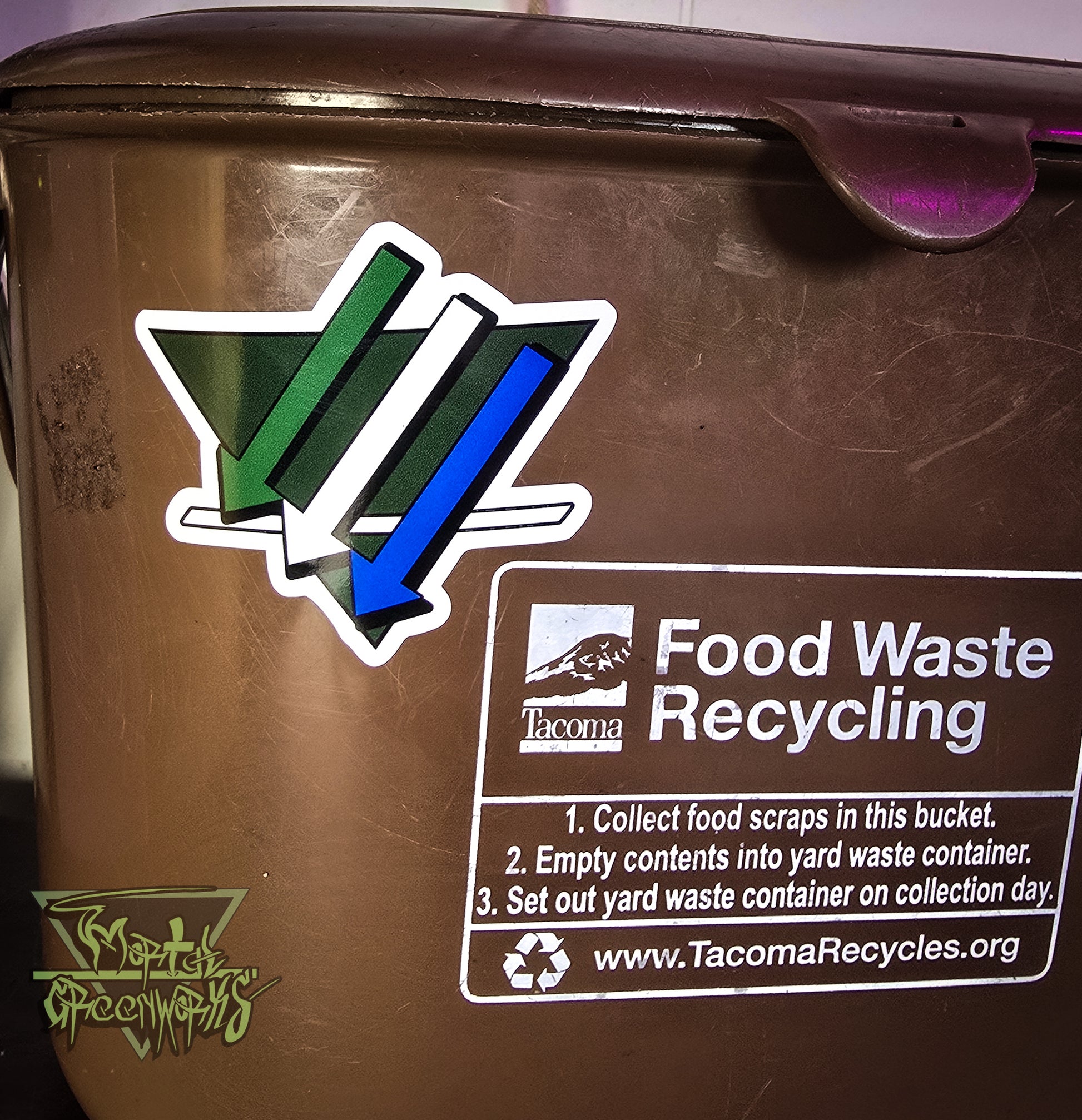 A close-up of a brown recycling bin with food waste recycling instructions and TacomaRecycles.org logo. Next to this section is the Cascadia Climate Front Logo.