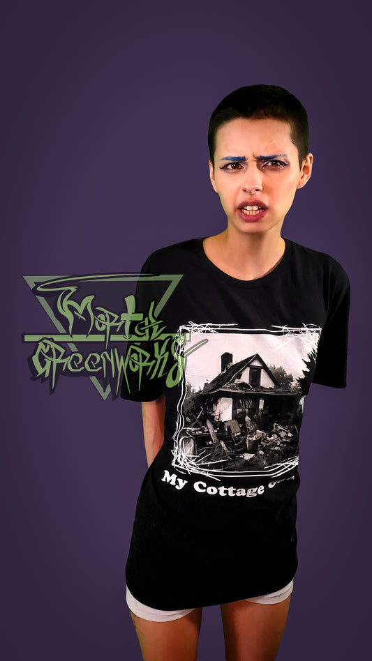 Photo of an expressive person wearing a black t-shirt with a cottage graphic design and text that says "My Cottage" on a purple background.