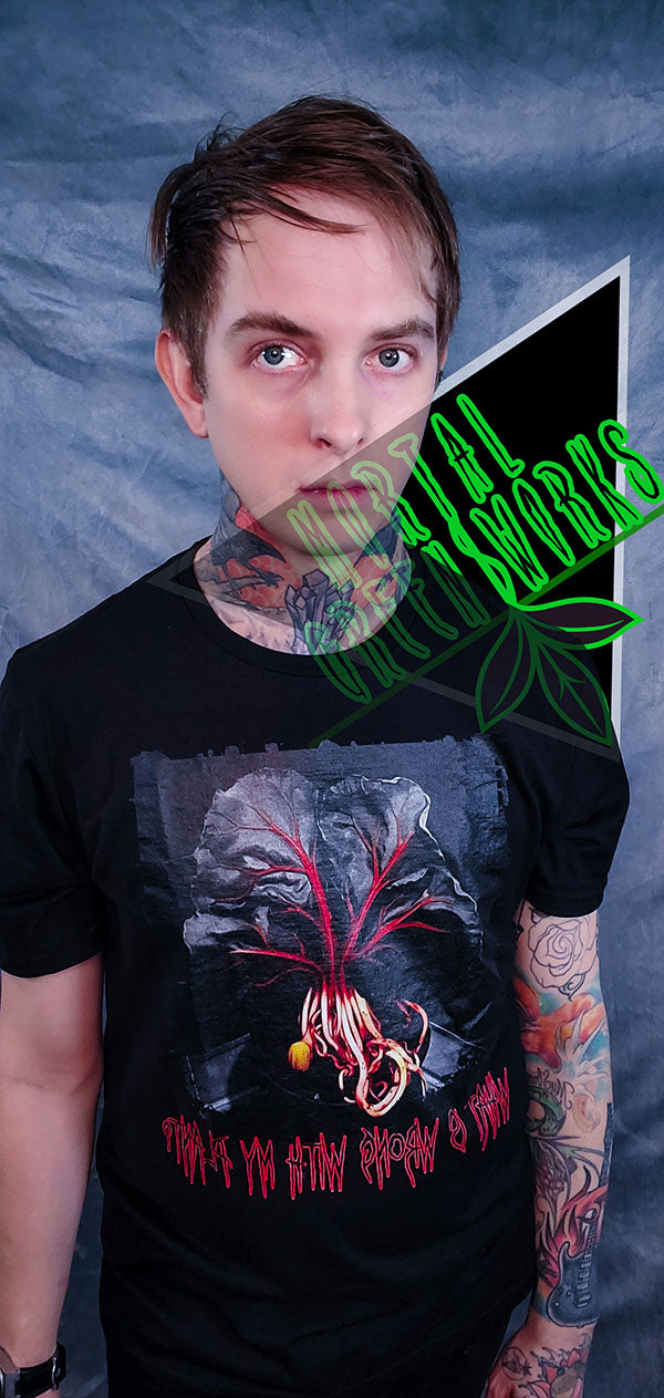 Close-up of a man in a black T-shirt with a red-veined fiddle leaf fig graphic and horror-inspired text that reads: "What is wrong with my plant?"