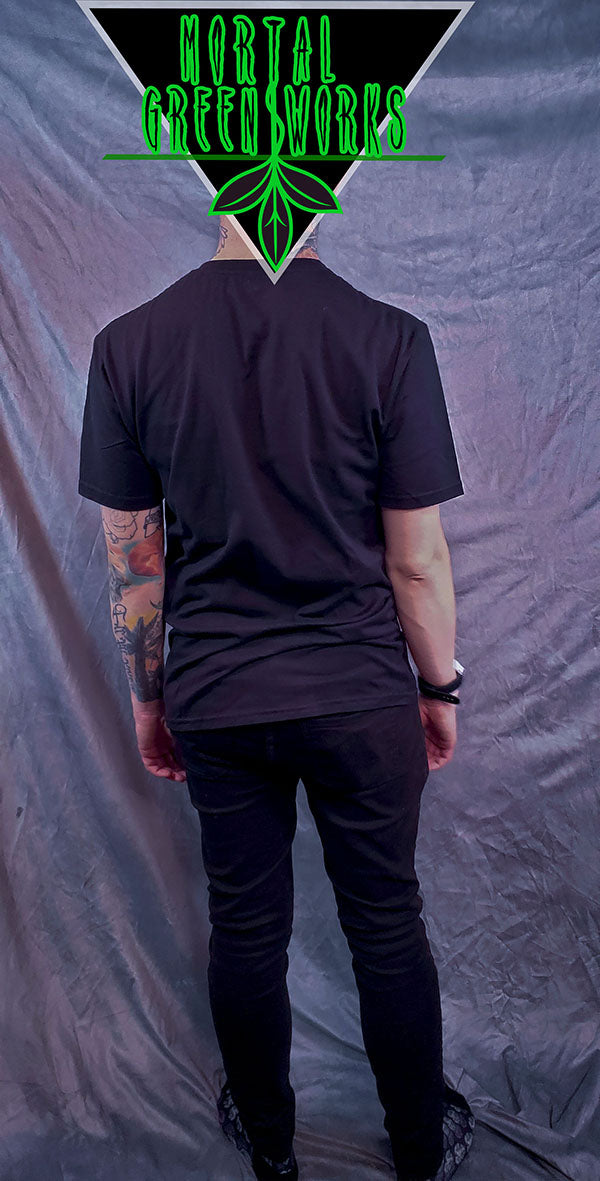 Back view of a man in a black T-shirt with the 'Mortal Greenworks' leaf logo at the top.