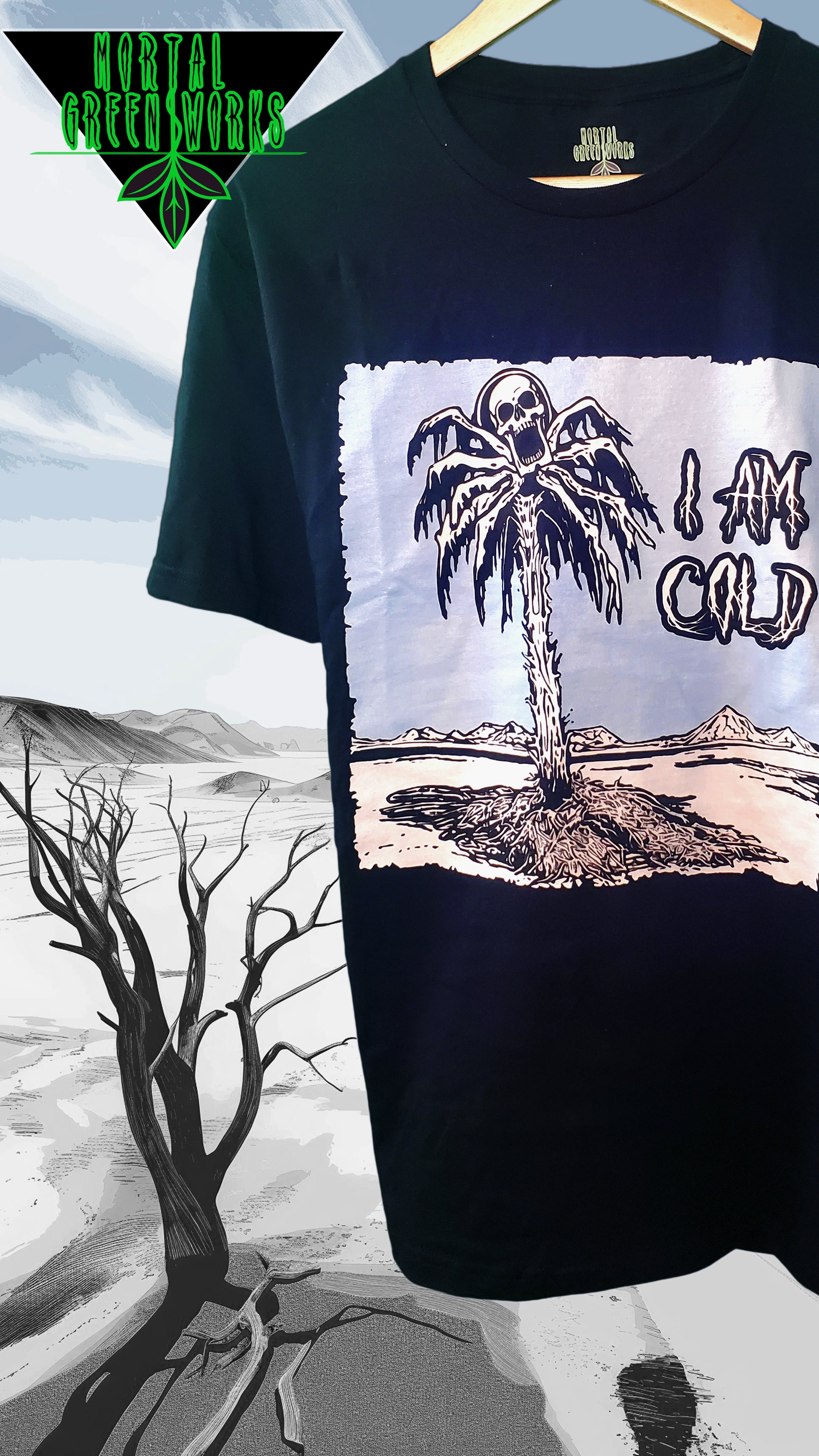 Black t-shirt with a skeletal figure in a palm tree, surrounded by a frozen, desolate landscape, captioned 'I AM COLD' from Mortal Greenworks.