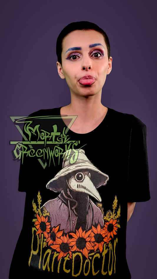 A person sticking their tongue out at the camera. She is wearing a black t-shirt with a plague doctor graphic design on a purple background. Below the graphic reads: Plant Doctor.