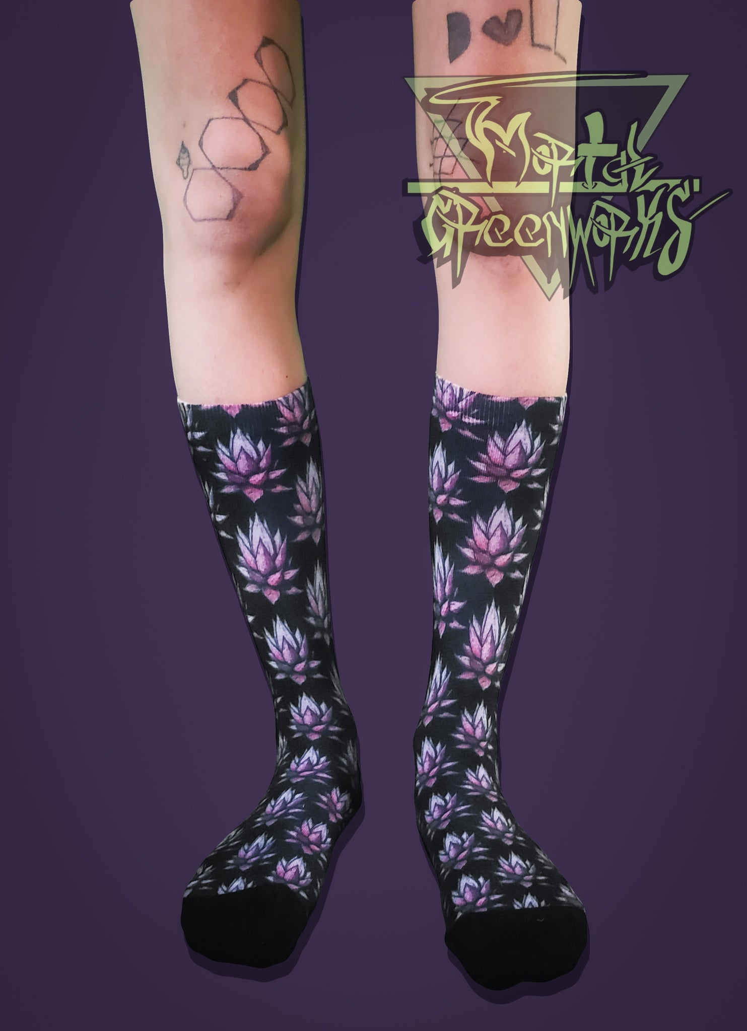Purple Agave patterned knee-high socks worn by a person with tattoos on a purple background.