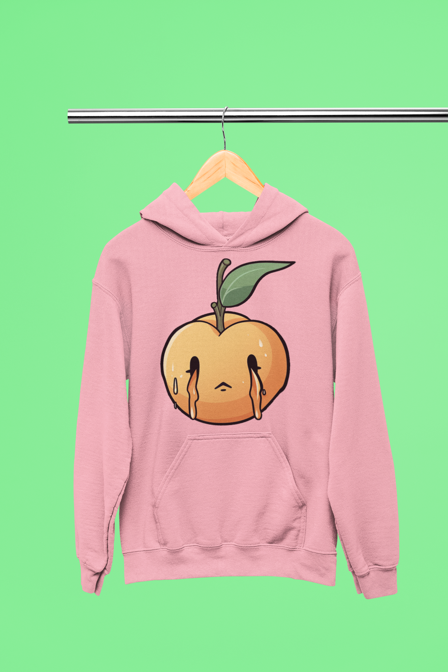 Pink hoodie on a hanger with a melting peach design on the front, displayed against a bright green background.