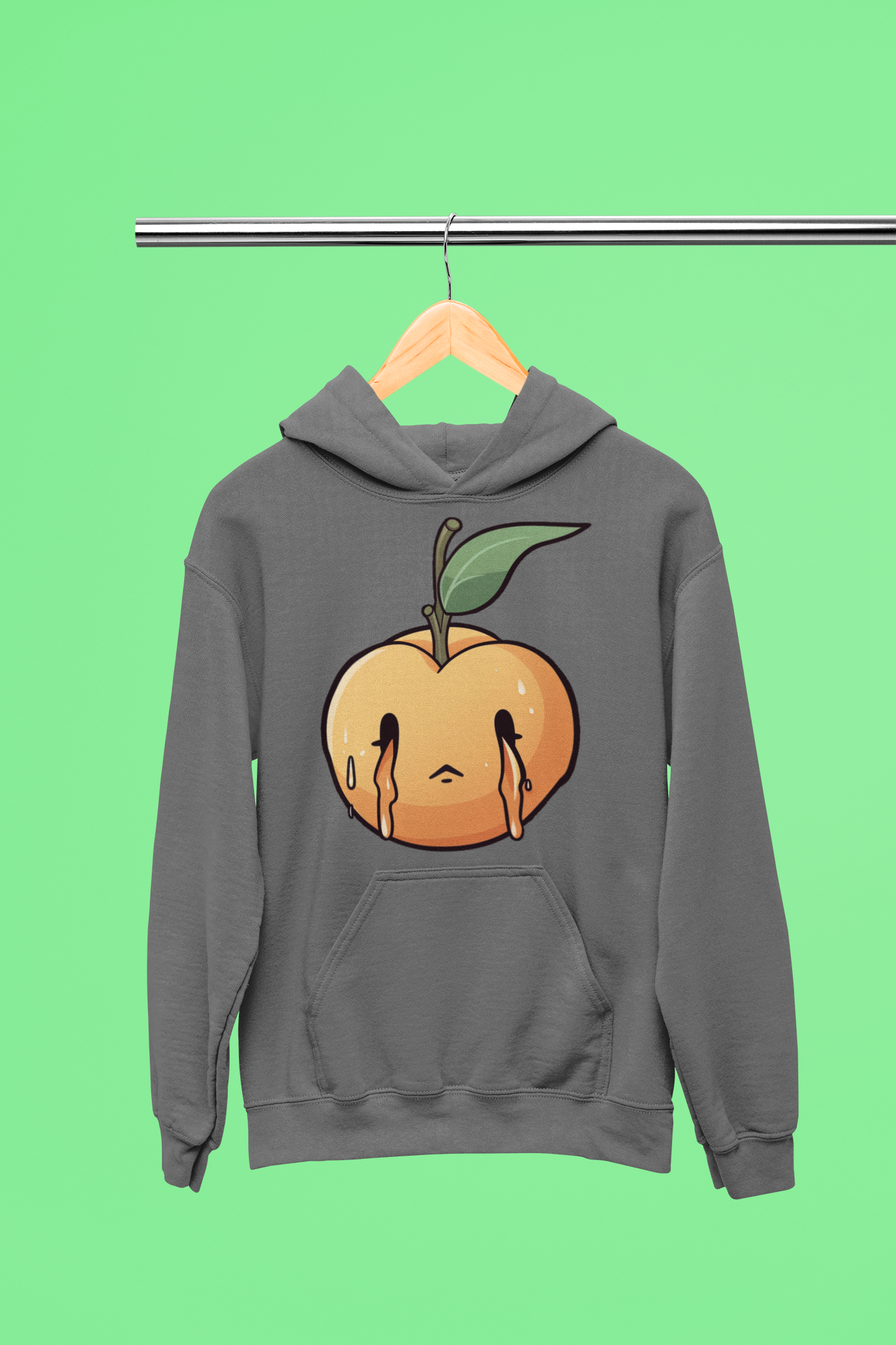 grey hoodie hanging from a steel bar against a green background. The hoodie has a design of a melting peach with a leaf on the front.